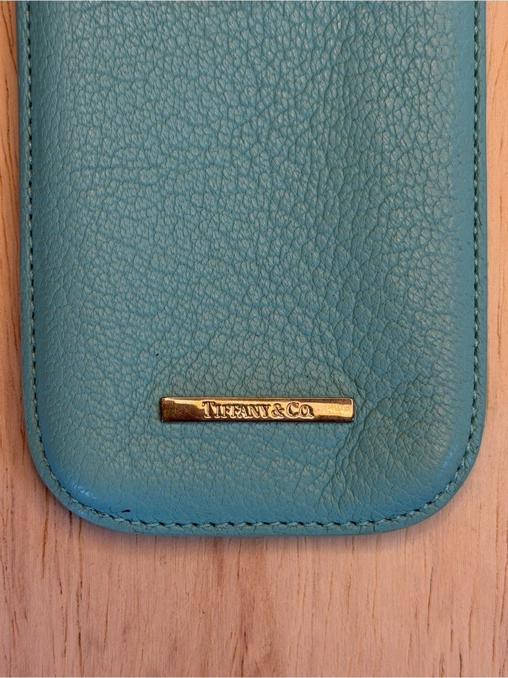 Tiffany & Co. turquoise pebbled leather phone sleeve with gold logo